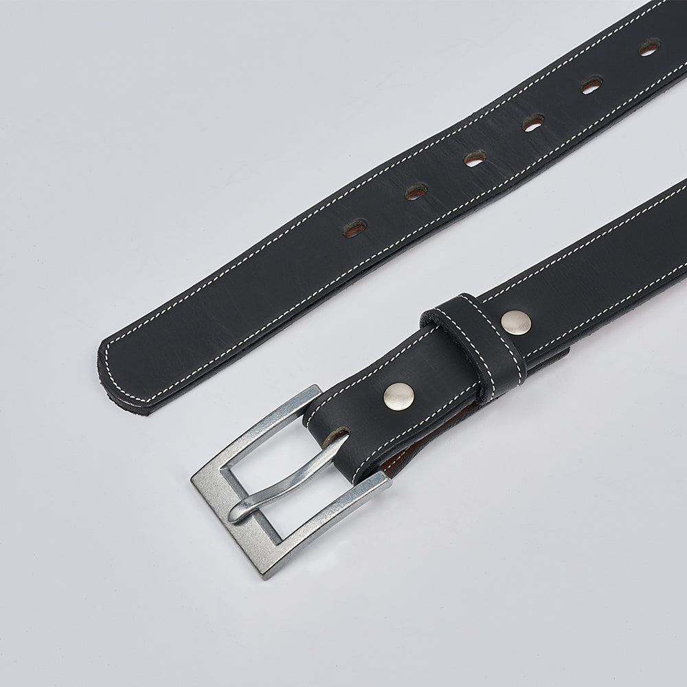 The Heritage Bison by Hanks Belts is a rugged black bison leather belt with white stitching, a silver rectangular buckle, and multiple adjustment holes, shown laid flat on a light gray surface.