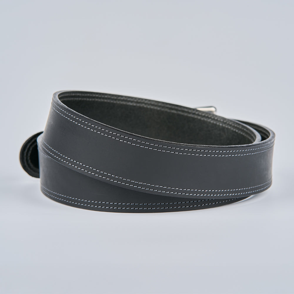 The Wyoming Bison by Hanks Belts is a black coiled belt with white edge stitching, displayed on a plain light gray background.