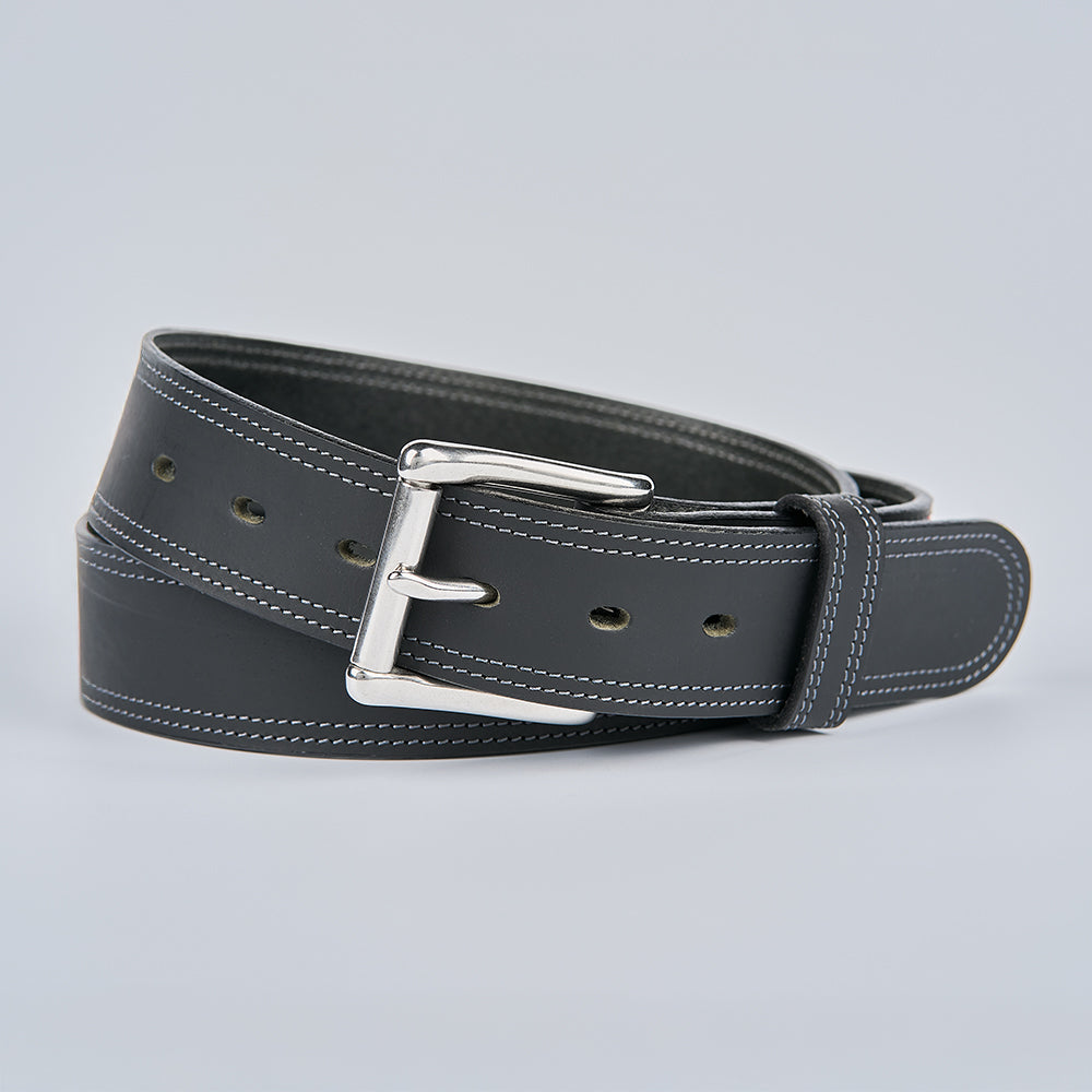The Wyoming Bison by Hanks Belts, a black men's casual belt with white stitching and a silver metal buckle, is coiled neatly against a plain light gray background.