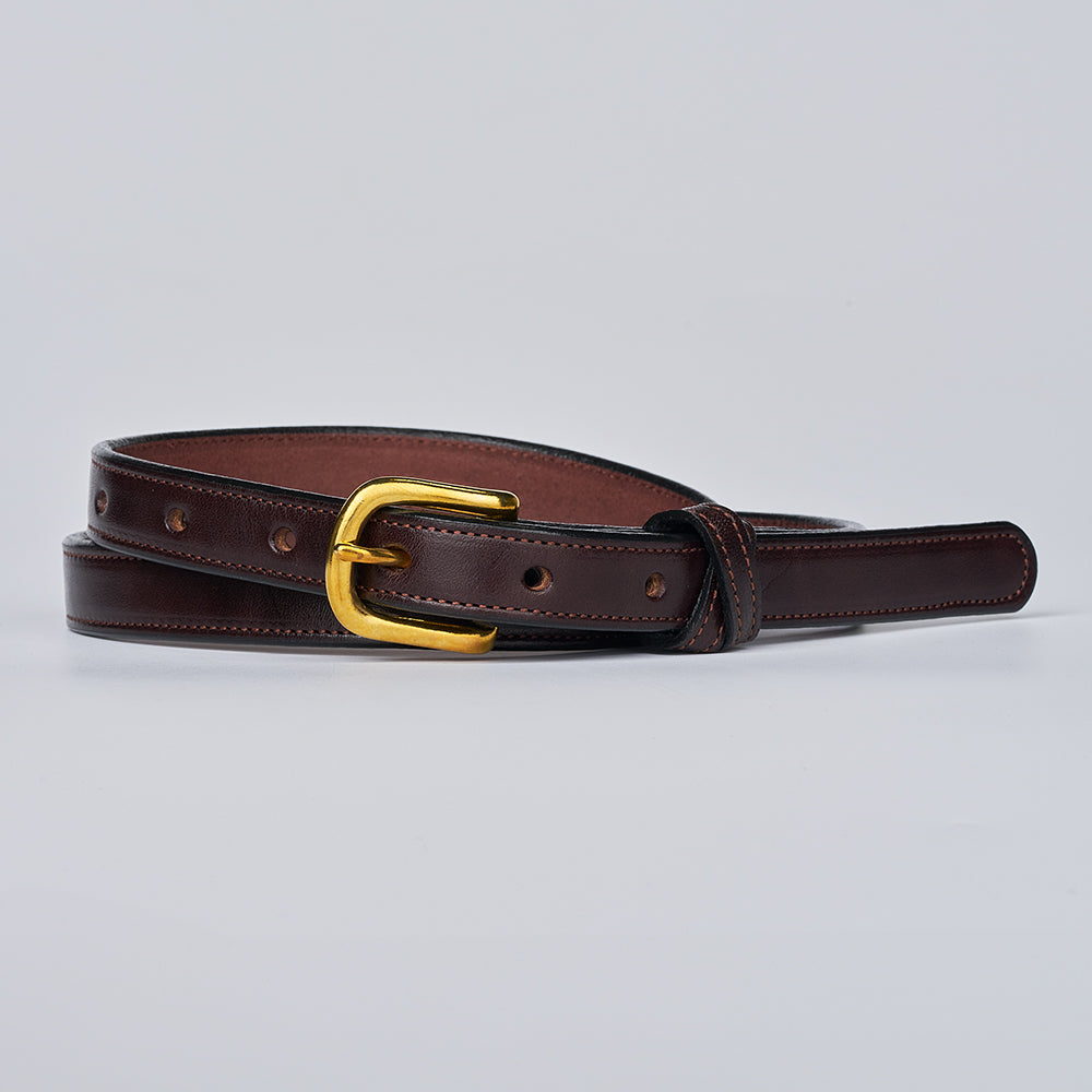 The Dixie by Hanks Belts is a dark brown women's English Bridle leather belt made in the USA, featuring a gold buckle, edge stitching, and multiple adjustment holes. Shown laid flat on a light gray background.