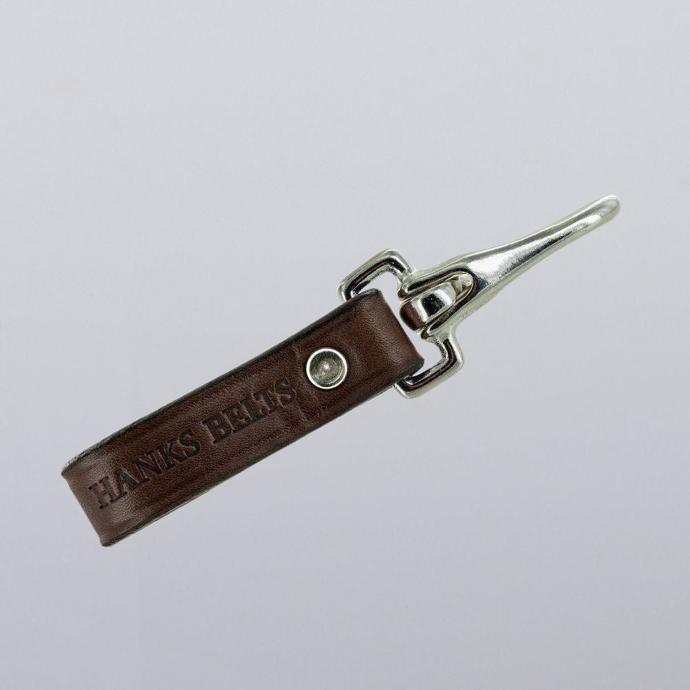 The Canyon Keychains by Hanks Belts feature brown leather with "HANKS BELTS" embossed, a silver rugged clip, and are shown against a plain light gray background.
