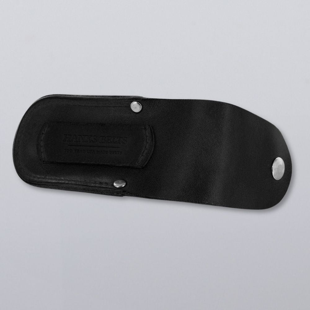 The Canyon Utility Sheath and Mag Case by Hanks Belts features black bridle leather, a snap closure, metal rivets, and embossed inner flap text. Photographed on gray; USA-made craftsmanship shines in every detail.