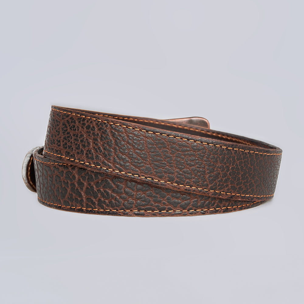 The Yellowstone by Hanks Belts is a rugged leather belt featuring textured grain and light brown stitching, shown rolled up against a plain light gray background.