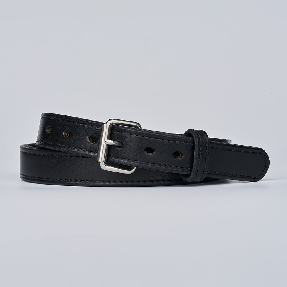 The Steel Core - 1.25" by Hanks Belts, a black leather gun belt with a silver rectangular buckle and multiple adjustment holes, coiled and displayed on a light gray background.