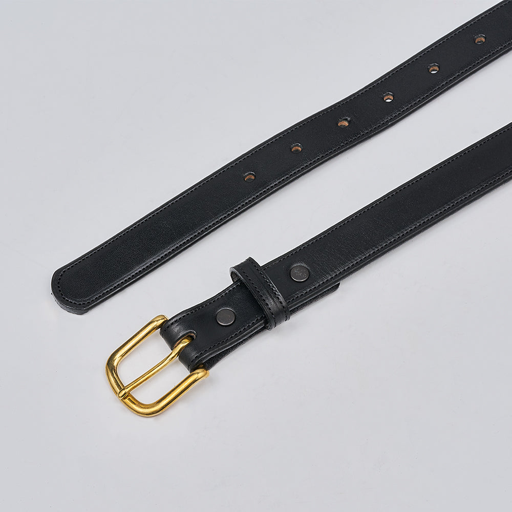 The Addyson - 1" by Hanks Belts is a classic leather belt crafted from English Bridle Full-Grain Leather with a brass buckle. It’s laid flat on a light gray surface, featuring multiple adjustment holes and simple edge stitching.