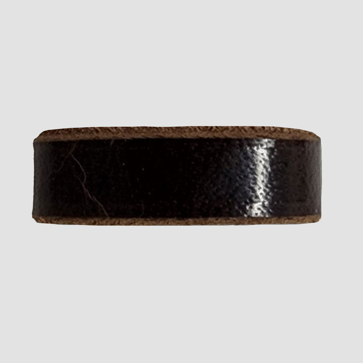 A close-up of the Hanks Belts 1.5" Glazed #5 Keeper in chocolate brown, perfect for a 1.5" jean belt, shown against a light gray background. USA-made craftsmanship is evident in the details.