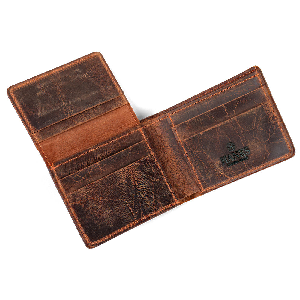 The Powell Bison Bifold with ID Window by Hanks Belts features an open brown bison leather design, multiple card slots and compartments, a worn texture, the Hanks logo inside, and reliable RFID blocking protection.