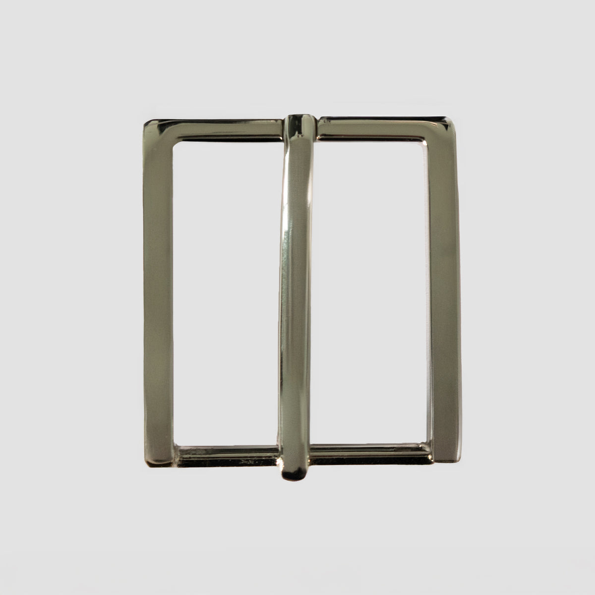 The Hanks Belts 1.25" Nickel #22 Buckle features a rectangular solid brass build with a nickel finish and central bar, offering a minimalist look against a plain light gray background.
