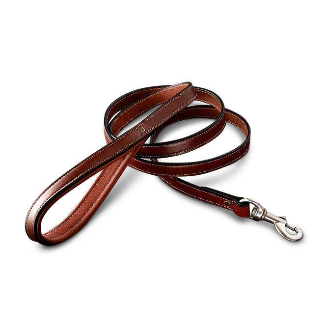 The Hanks Belts Rover Standard Leash in Oak features English Bridle leather with white stitching, a padded handle for comfort, and a metal clasp for collars, shown against a white background.