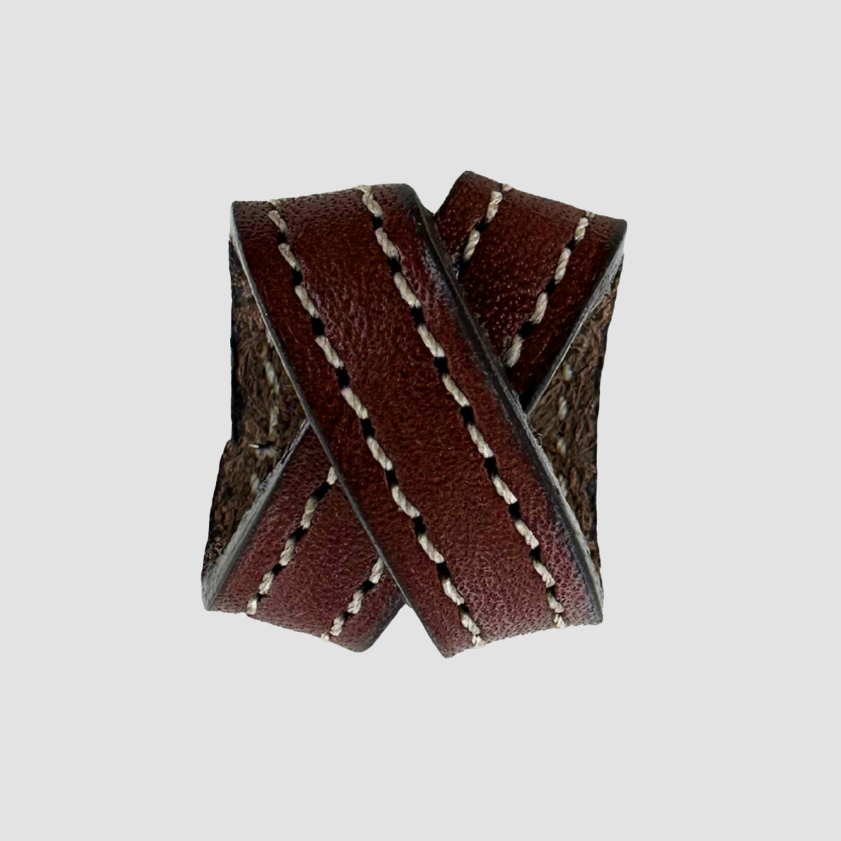 The Hanks Belts .75" Crossover #8 Keeper features two overlapping bands of brown English bridle leather, each edged with white stitching, shown against a plain gray background.