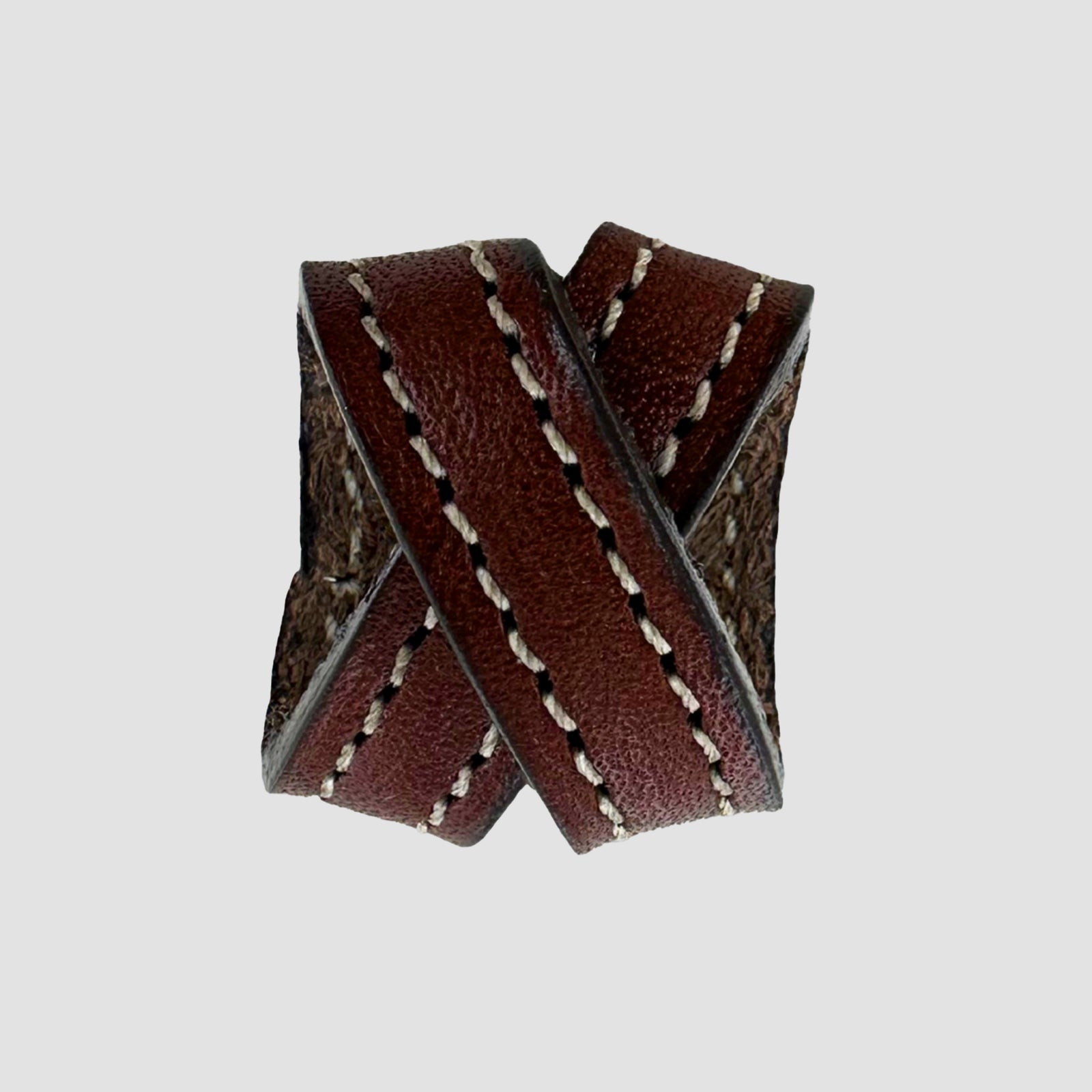 The Hanks Belts .75" Crossover #8 Keeper features two overlapping bands of brown English bridle leather, each edged with white stitching, shown against a plain gray background.