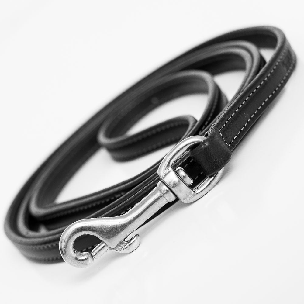 The Hanks Belts Rover Standard Leash is a coiled black English Bridle leather dog leash with white stitching, padded handle, and shiny metal clasp, shown on a white background.